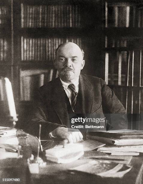 Portrait of Soviet leader Vladimir Ilich Lenin sitting alone at a desk. Undated photo, filed 1931.