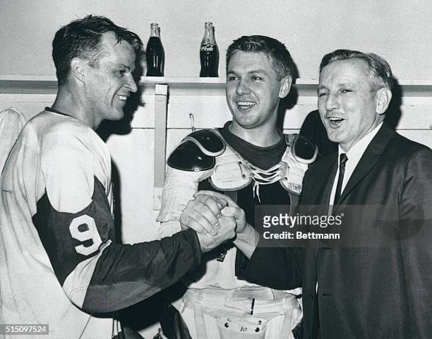 Coach Sid Abel has enthusiastic congratulations for two of his players, who led the Detroit Red Wings to 4-2 victory over the Chicago Black Hawks in...