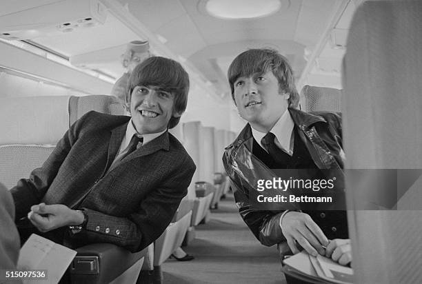 Los Angeles: One half of the Beatles singing group, George Harrison and John Lennon, are shown aboard their plane here prior to taking off for...