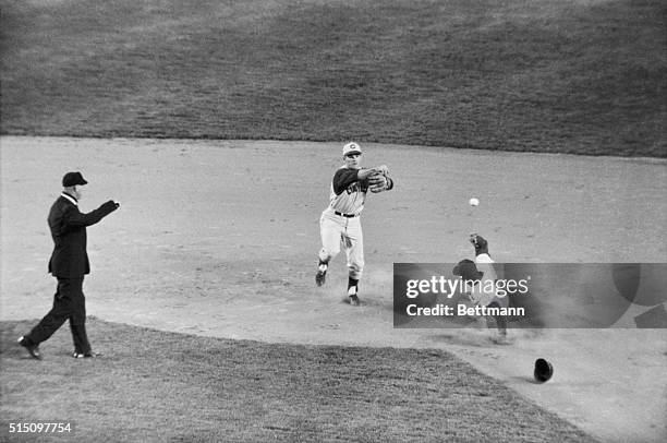 Rightfielder George Altman of the New York Mets loses his protective helmet and is forced out at second by Pete Rose of the Cincinnati Reds during...