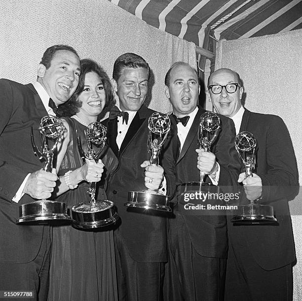 Mary Tyler Moore who plays the television wife of Dick Van Dyke on the Dick Van Dyke Show gets a big kiss from Van Dyke after they won Emmy's as...
