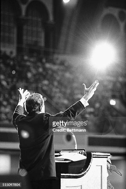 Evangelist Billy Graham raises his arms in supplication as he closes the American and Southern Baptist Conventions.