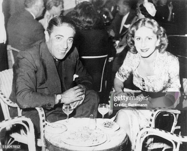 Aristotle Onassis sits with his first wife Athina at an Athens cafe.