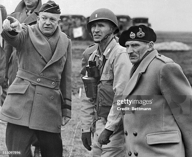 General Dwight D. Eisenhower shows the strain of his command in his expression as he and Britain's Field Marshall Bernard Montgomery , his deputy...