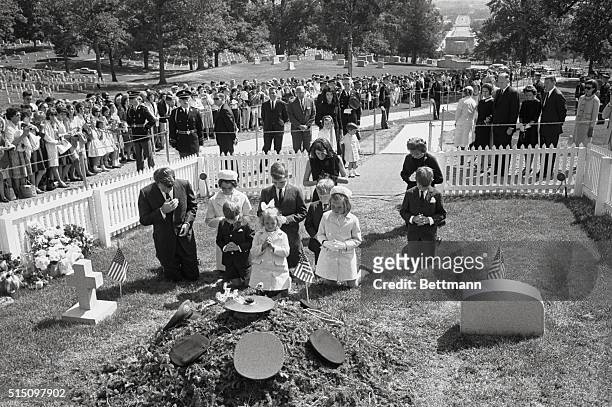 Attorney General Robert F. Kennedy and family pray at the grave of the late President here, on what would have been his 47th birthday. The children...