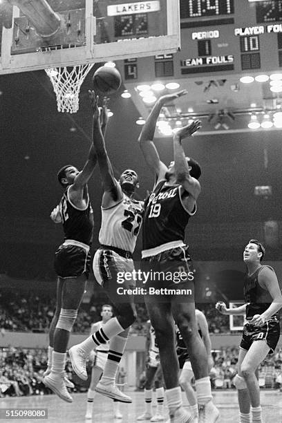 Lakers' Elgin Baylor grabs the rebound from Detroit Pistons' Ray Scott and Reggie Harding during second period action at the Los Angeles Sports...