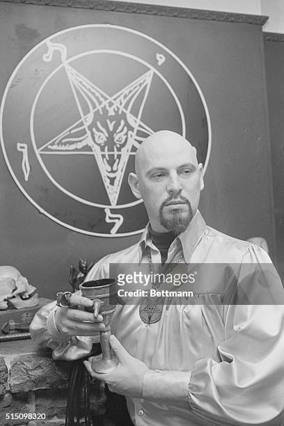Satan's Church is a Profitable Enterprise. . Six-foot LaVey, sporting a shaven head and neatly trimmed ming beard, stands in front of his magic...