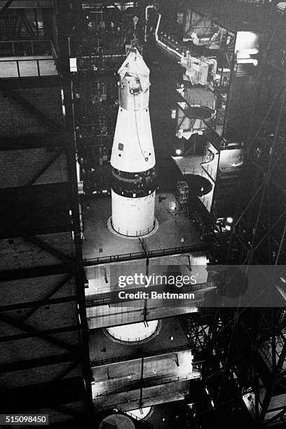 The first Apollo spacecraft, since the Apollo 1 "death ship" in which three astronauts died January 27th, is lowered atop a Saturn-5 moon rocket here...
