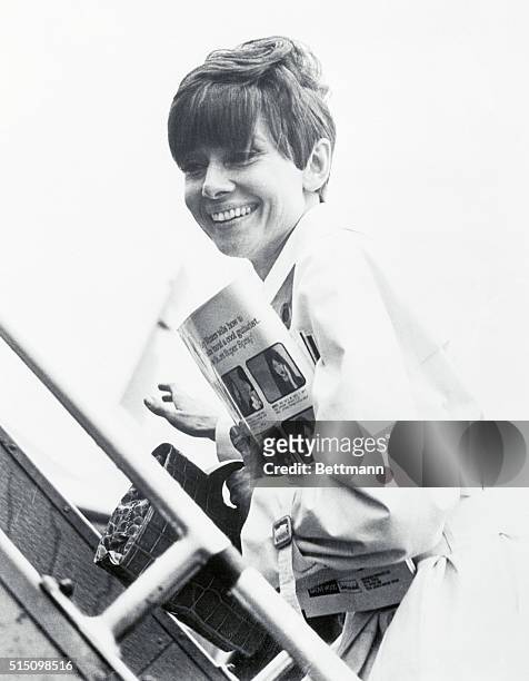 It was nice, but going home feels good... That's apparently how actress Audrey Hepburn felt as she boarded a plane at London Airport, headed for...