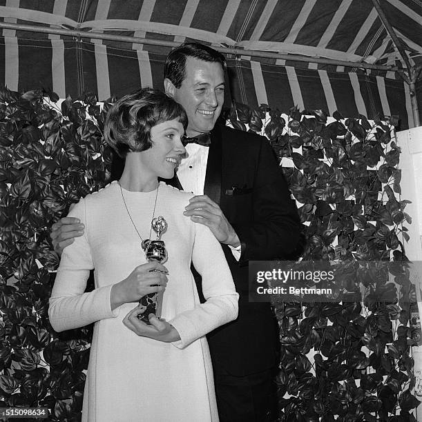 Lovely Julie Andrews wears a proud smile as she holds her Golden Globe award as the female world film favorite of 1966 during the Hollywood Foreign...