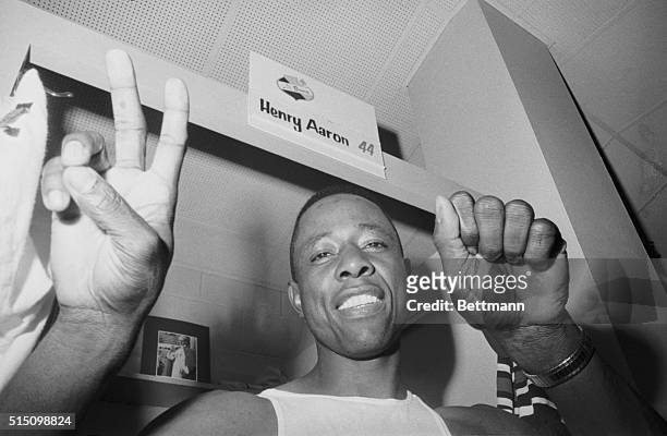 Atlanta Braves slugger Henry "Hank" Aaron happily displays two fingers and a closed fist indicating zero to signify his league leading 20th homer,...