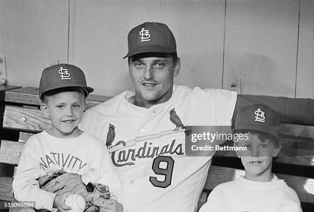 St. Louis Cardinals Roger Maris , gets together with his sons Kevin and Roger in dugout before Cards-Dodgers game here 4/13. The game was called...