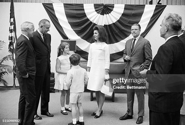 President Lyndon Johnson chats with Mrs. John F. Kennedy and her children, Caroline and John, Jr., prior to the christening of the aircraft carrier...