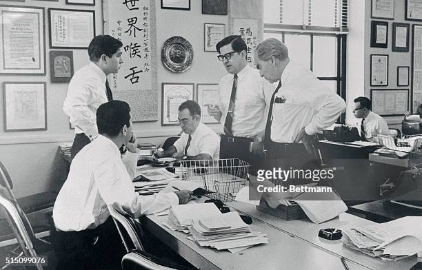 In an improvised newsroom at the New York Times, editors work on a pilot issue of a New York afternoon newspaper. The paper is being edited by Times...