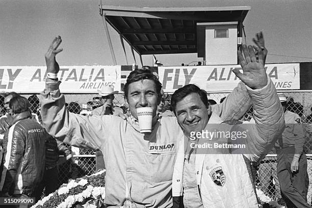 Drivers Jo Siffert and Hans Herrmann, of the winning Porsche 907 factory prototype, which led a field of three Porsches across the finish line in the...