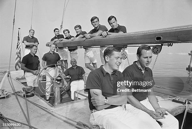 Bus Mosbacher, at the helm, skipper of the America's Cup defender, Intrepid, winner of the first three races in the America's Cup series, poses with...