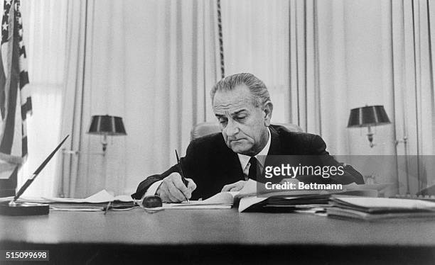 The White House released this photo 1/25 of President Johnson signing the Executive Order ordering certain units of the Ready Reserve of the Naval...