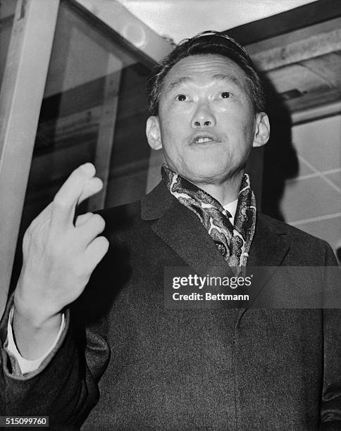 The man keeping his fingers crossed at London Airport is not a nervous passenger. He's Lee Kuan Yea, the Singapore Prime Minister. This afternoon, he...