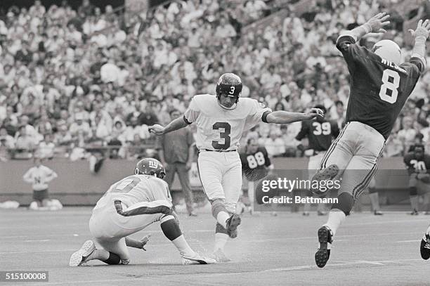 St. Louis: New York Giants' Pete Gogolak kicks extra point as Cardinals' Larry Wilson leaps to try and block the kick in 2nd quarter of the New York...