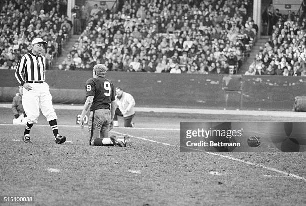 Cleveland, Ohio: Washington quarterback Sonny Jurgensen, minus helmet, appears to be looking up and asking referee Norm Schacte if anyone got the...