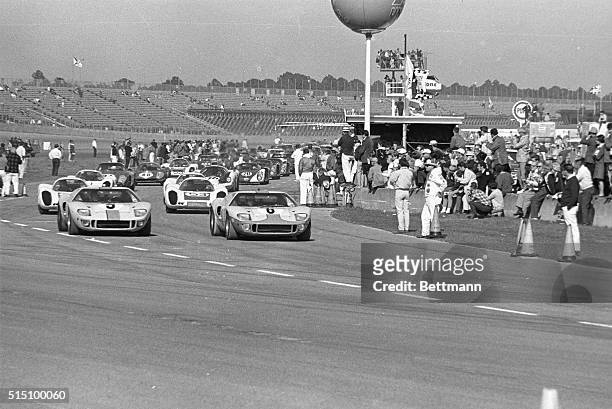 Two Ford GT-40s, followed by four Porsche 907 prototypes, lead the field of 64 cars as they thunder toward the green flag which signaled the start of...