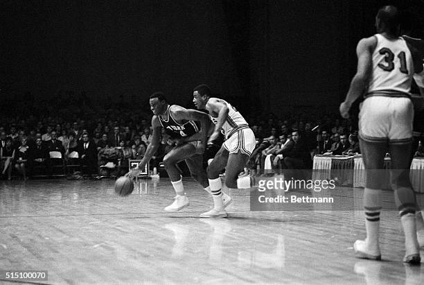 New York Knicks' Cazzie Russell bring the ball up court as he is closely guarded by St. Louis Hawks' Paul Silas in the first period of the...