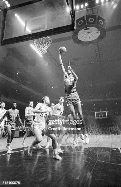 S version of the Empire State building, Lew Alcindor, is about to lob in two points as Al Stazinski and Ed Siudut of Holy Cross watch helplessly from...