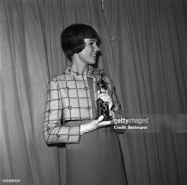 Actress Julie Andrews holds her Golden Globe Award of the Hollywood Foreign Press Association after being named the world's favorite film actress for...