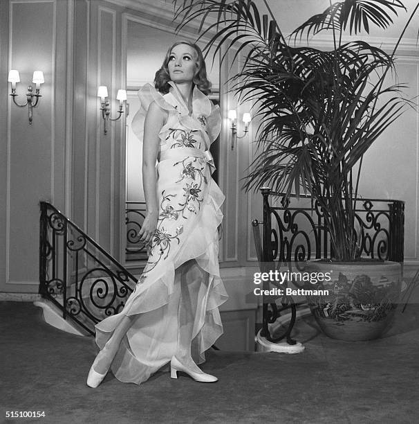 The frilly, fluffy look which Bohan showed for the evening line of Dior's Spring Collection is typified in this model. Fashioned of white organza...