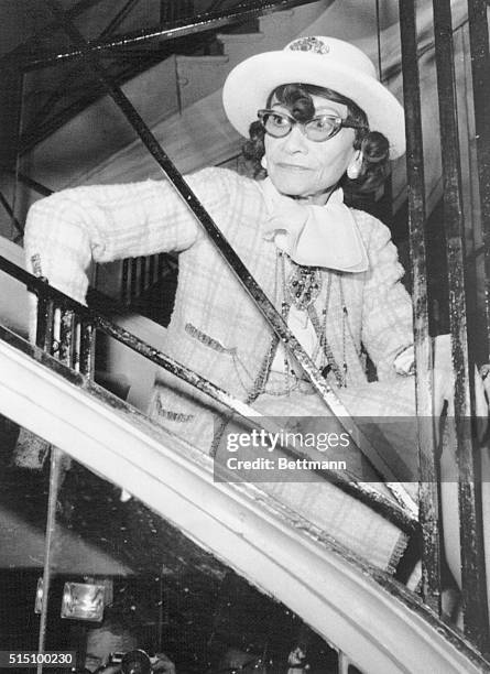 Seated on a staircase, French designer Coco Chanel watches her Spring-Summer 1969 collection being presented Jan. 28.
