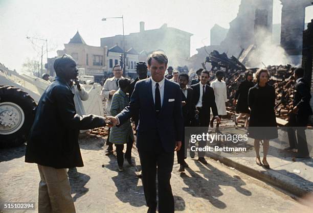 Senator Robert F. Kennedy, accompanied by his wife, Ethel, tours northwest Washington, which was devastated by fires in the wake of Martin Luther...