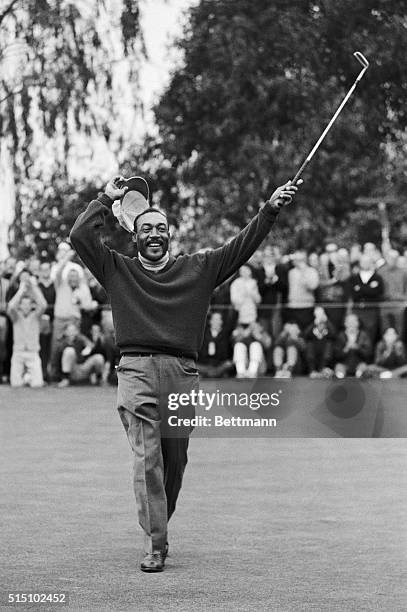 Charles Sifford of Los Angeles raises his putter jubilantly in the air after defeating South Africa's Harold Henning in a sudden death playoff during...
