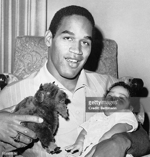 Arnelle Simpson, two-month-old daughter of Heisman Trophy winner O.J. Simpson, does not seem too interested in her father or the toy buffalo he is...