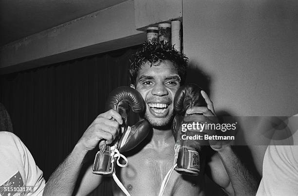 Jubilant Australian Lionel Rose embraces the gloves that won him the world bantamweight title here, February 27th, as he punched out a unanimous...