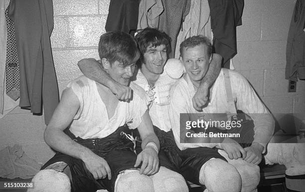 Boston's heroes, Bobby Orr , Derek Sanderson and Wayne Cashman relax in dressing room at Madison Square Garden here, April 16, after the Bruins...