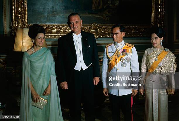 Bangkok, Thailand: President and Mrs. Lyndon B. Johnson pose with King Bhumibol and Queen Sirikit before the start of a formal dinner in the Chakri...