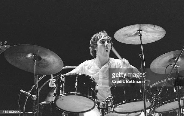 Keith Moon, drummer with the British rock group The Who, plays the drums intensely during a performance of the rock opera Tommy at the Metropolitan...