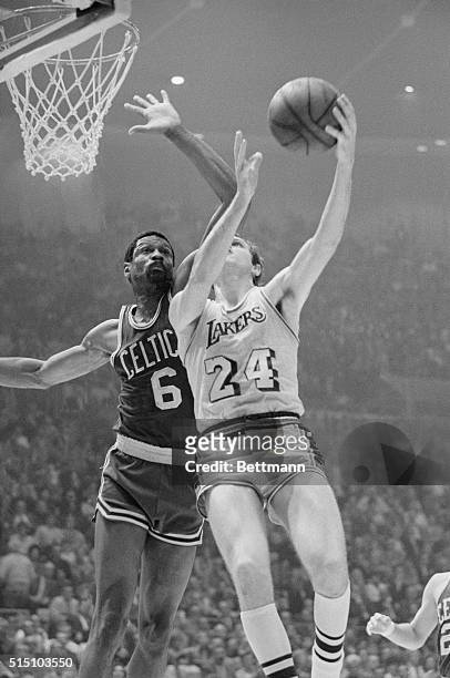 Boston's player coach Bill Russell blocks a shot by Keith Erickson as the Celtics go on to defeat the Lakers 108-106 in the final game of the NBA...