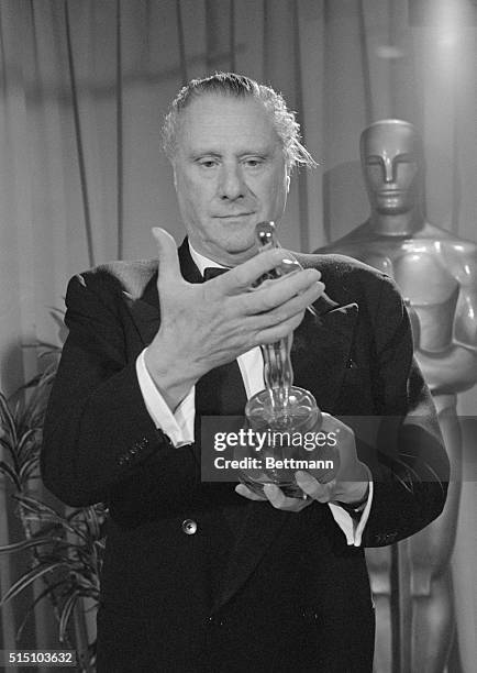 "Best Director." Los Angeles, California: British film director Sir Carol Reed admires "Oscar" presented him as best director for the musical film...