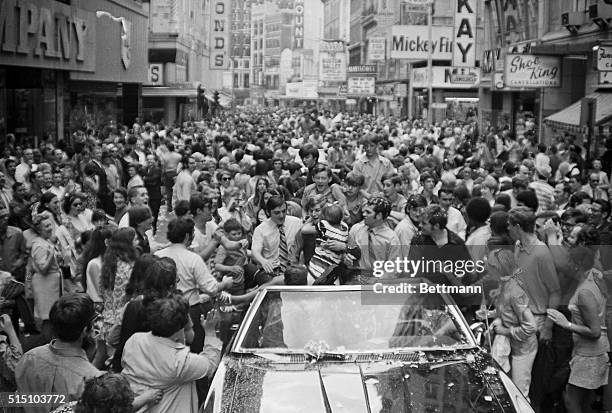 Surprised Bobby Orr finds himself being hugged by an avid girl fan who leaped into his arms during a victory parade for Boston Bruins in Boston's...