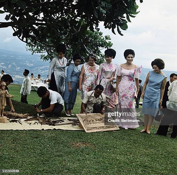 While their husbands occupied themselves at a summit meeting on the war in Viet Nam, these ladies kept busy touring and meeting with natives. Here at...