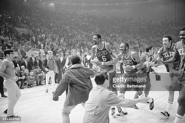 Boston Celtics player-coach Bill Russell and guard Emmette Bryant head for the showers after the Celtics defeated the los Angeles Lakers 108-106 to...