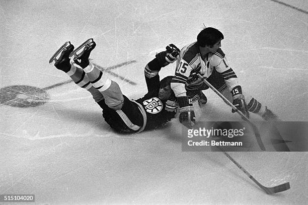 Bobby Orr , the league's scoring and assist leader, is dropped by New York Rangers defender Jim Neilson during first period play of Game 2 of the NHL...
