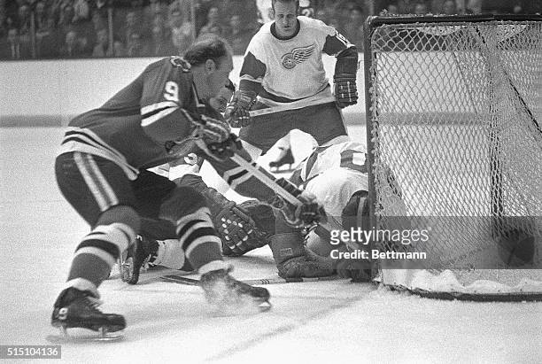 Black Hawks Bobby Hull almost gets a goal as the score was disallowed because Detroit goalie Roy Edwards slid into net with the puck in the second...