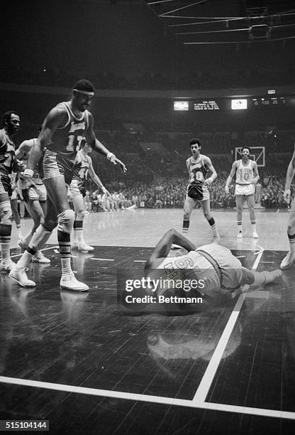 Willis Reed Down and Out. New York: Wilt Chamberlain, Los Angeles Lakers' big man, stands over his New York Knicks' counterpart as Willis Reed hits...