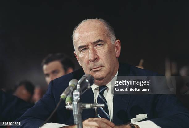 Attorney General John Mitchell is shown speaking into a microphone in this closeup photo.