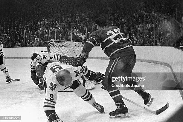 Montreal Canadiens Frank Mahlovich takes Chicago Black Hawks Bobby Hull out of position seconds before Jacques Lemaire scored a goal on the Black...