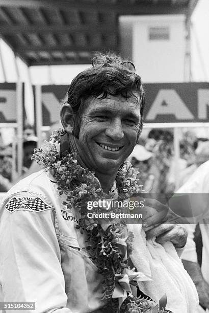Donnie Allison displays joy and heat fatigue as he poses for photographers in victory lane following his win of the 12th Annual Firecracker 400 at...