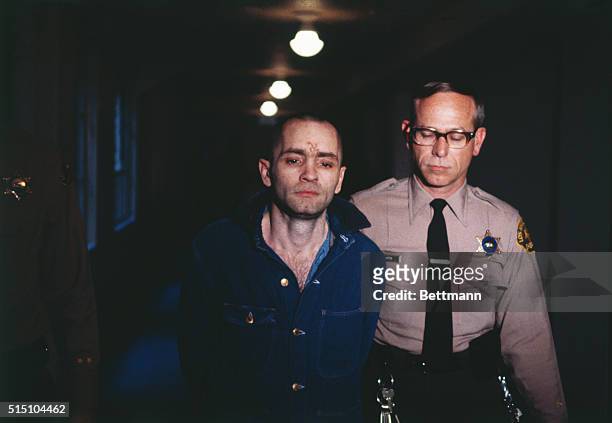 Los Angeles, California: Charles Manson, convicted hippie leader, is sullen as he is led back into the courtroom to hear the penalty he and this...