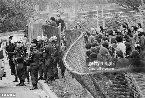 Washington: Antiwar Demonstrators try to push down a fence behind which they were corralled on a practice field alongside RFK Stadium 5/3. More than...